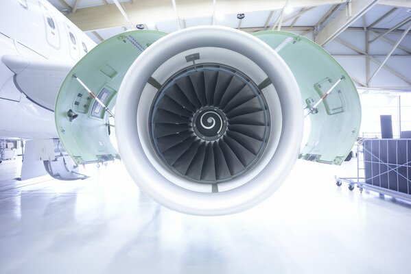 Visual image of an airplane turbine in a hangar