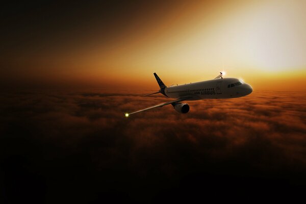 Passenger plane in the clouds at sunset