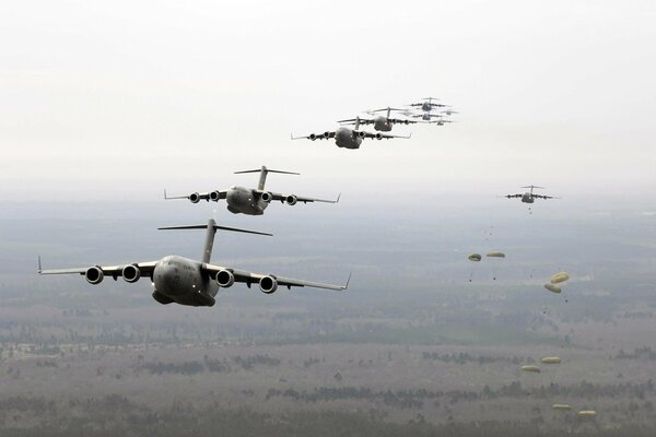 Paratroopers with parachutes flying in the sky