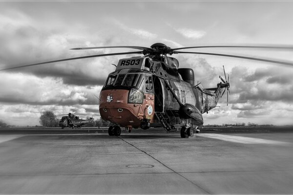 Sicorskiy s- 61 / sh - 3 sea king helicopter on the background of dark sky and clouds