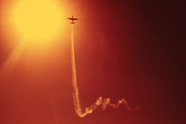 Sky with a plane flying into the sky performing a high speed stunt in the evening