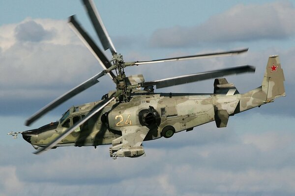 Ka-50 black shark tethys flies against the background of clouds