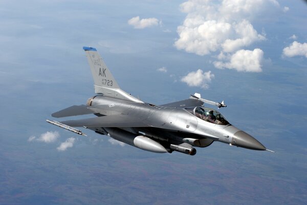 A military fighter is flying in the sky at a high altitude