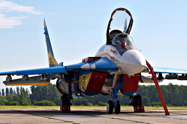 MIG 29 fighter jet on the runway with an open cockpit