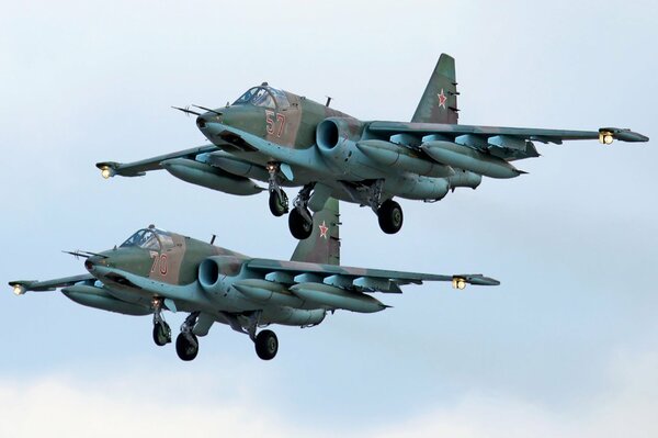 Two Su-25 aircraft in flight against the sky