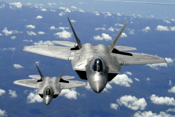 Fighters in white clouds above the ground