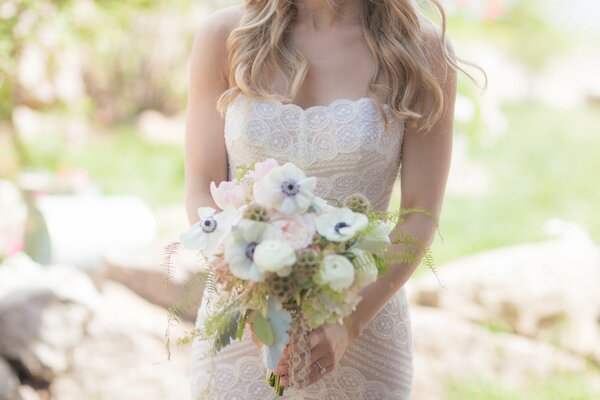 Beautiful wedding bouquet in the hands of the bride