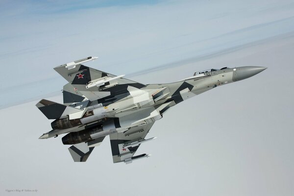 A Russian military fighter jet is flying in the sky