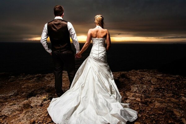 The bride and groom on the background of the evening