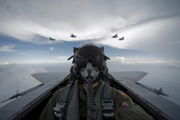 The pilot sits at the controls of the fighter