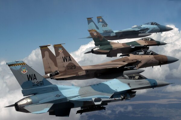 Fighters flying in a row against the sky