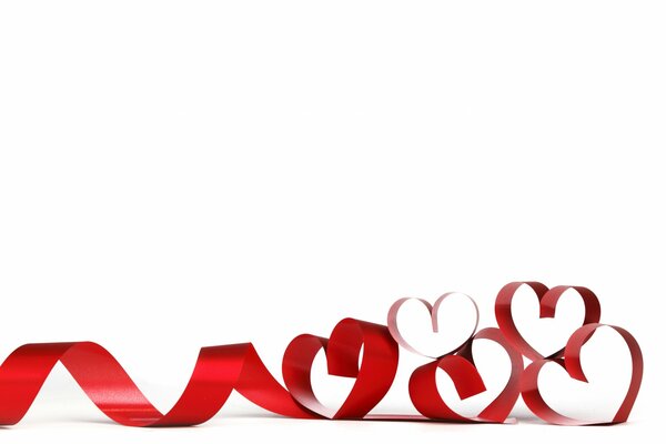 Hearts made of red ribbon on a white background