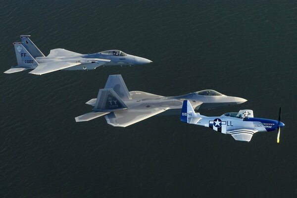 Three fighters are flying on a dark background