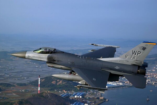 Flying over the city of a military fighter