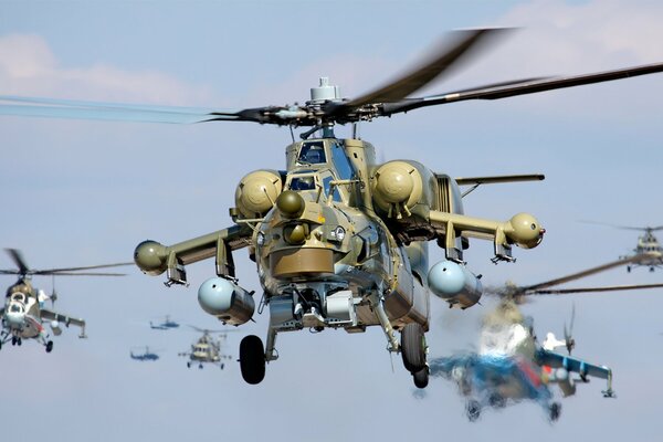 Green helicopter on the background of helicopters in the sky