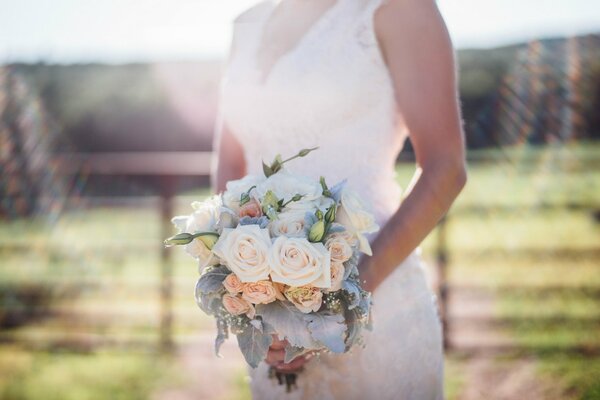 Beautiful wedding bouquet in the hands of the bride