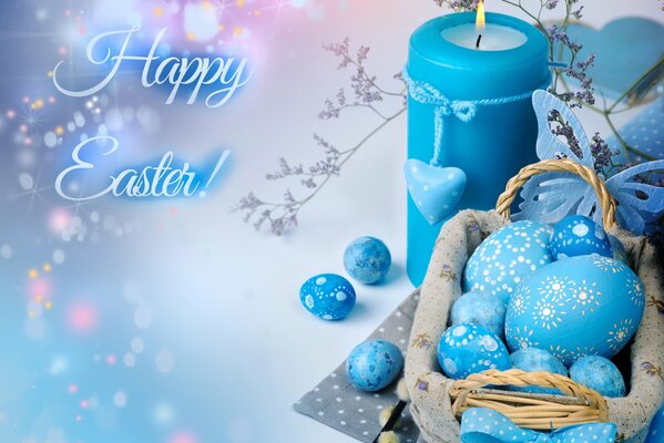 Magical Easter still life in pale blue with painted eggs and a candle