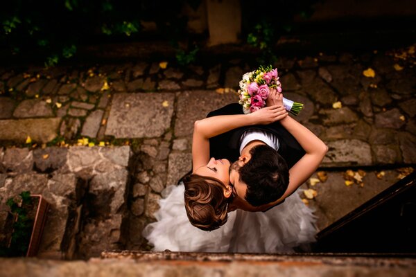 Photo shoot of the bride and groom with a bouquet