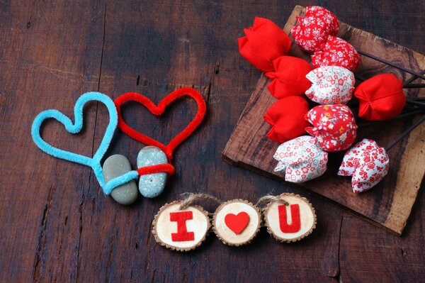 Romantic picture with artificial flowers and the inscription I love you