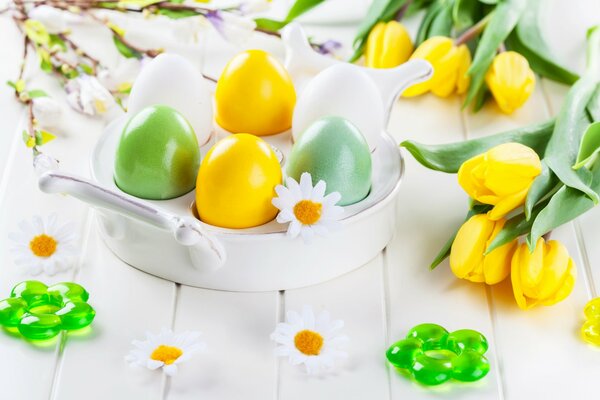 Easter eggs with tulips and chamomile