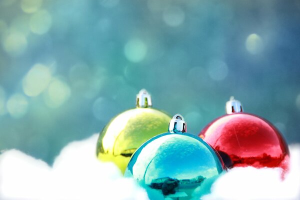 Three balls in the snow against the sky