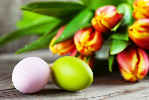 Easter eggs on a background of tulips