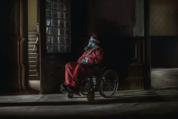 Santa Claus in a wheelchair with a gas mask