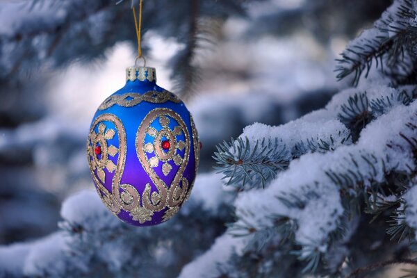 New Year s ball on a snow-covered branch