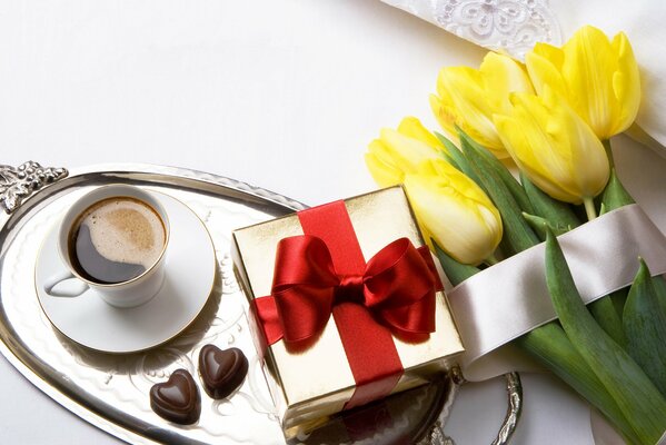 Romantic perfect good morning. Coffee, tulips and a gift, nothing extra