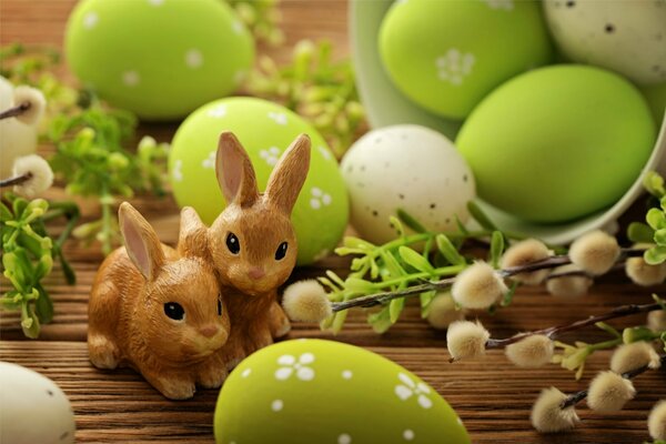 Cute bunnies for Easter decoration and willow on the background