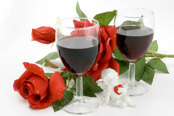 Two glasses of wine and a bouquet of roses