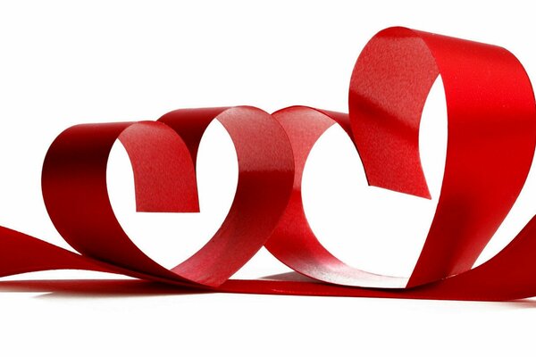 Two hearts made of red ribbon