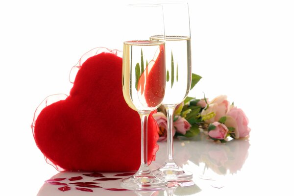 Champagne glasses on the background of a red heart