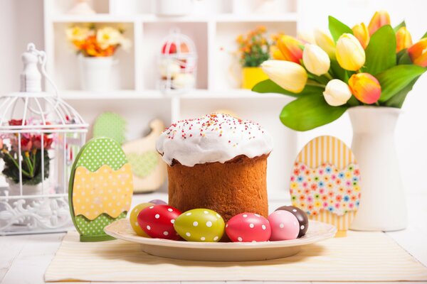 Easter cake with colored eggs on the festive table