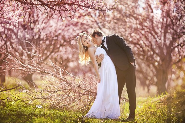 Wedding photo of the happy bride and groom in the grove