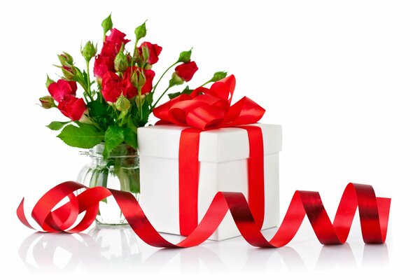 A gift with a red bow and roses