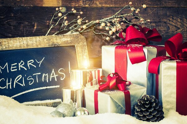 Gifts in boxes, candles and the inscription: Merry Christmas