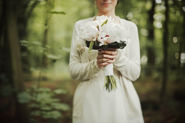 White peonies in the bride s wedding bouquet