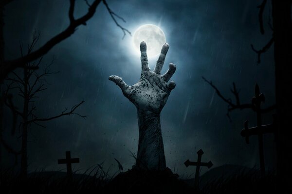 Halloween. The hand of a dead man in the cemetery