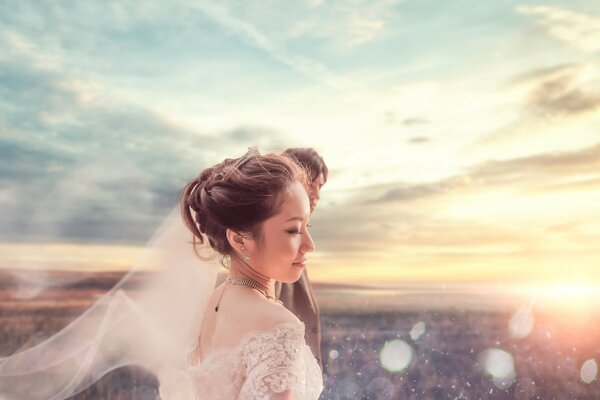 Bride with a photo on the background of dawn
