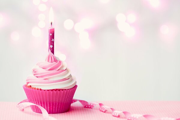 Cupcake with cream and candle