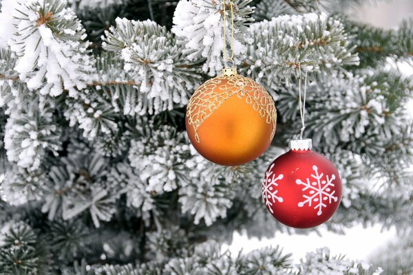 Weihnachtskugeln auf einem schneebedeckten Weihnachtsbaum