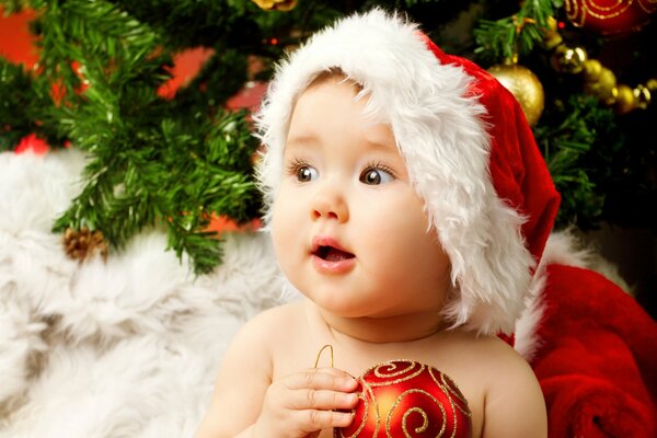 Enfant en chapeau de père Noël sur fond d arbre de Noël