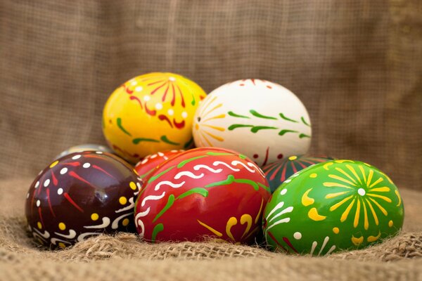 Bright Easter eggs on burlap