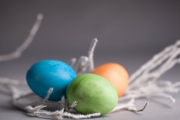 Three Easter eggs with a willow twig