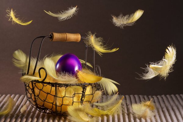 Basket of yellow feathers for Easter