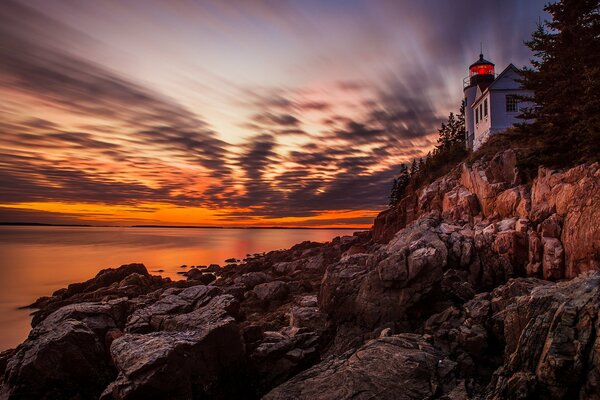 Sunset. cirrus clouds , lighthouse