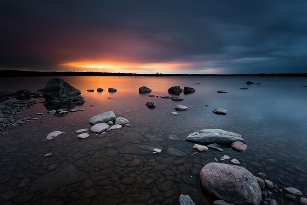 Sunrise at sea , coastal rocks