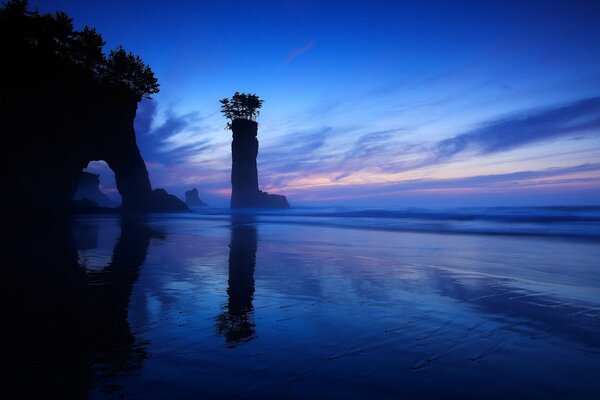 Arch in the sea on the background of the night sky