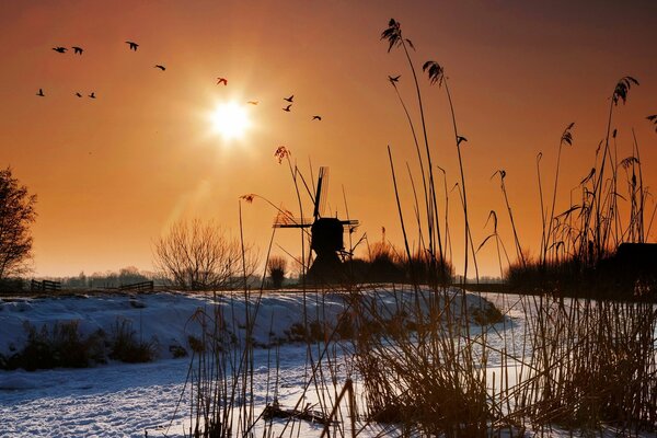 Landscape: mill in winter on the canal